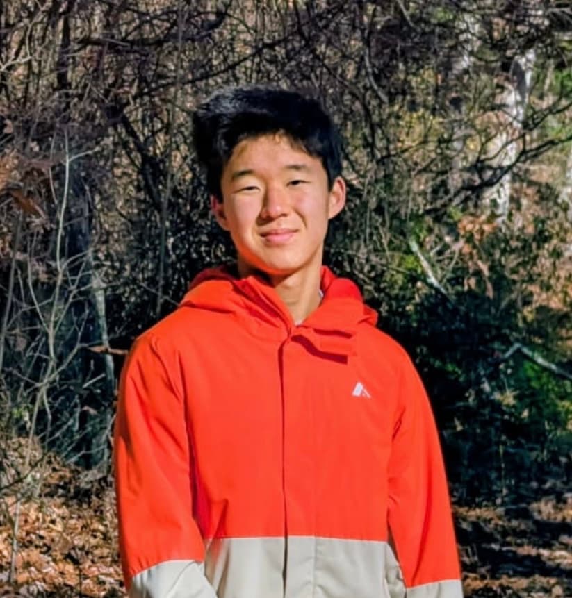 Evan Jo outdoors wearing a red jacket